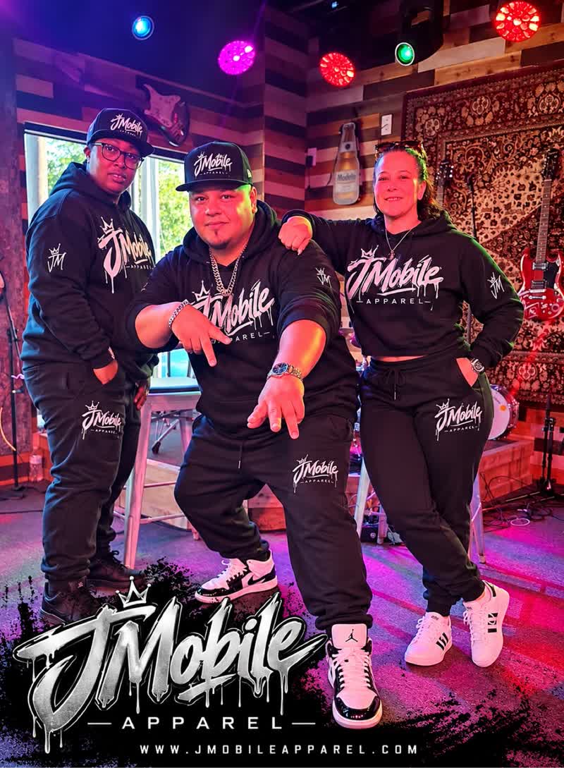Customers wearing JMobile hoodies in a music studio